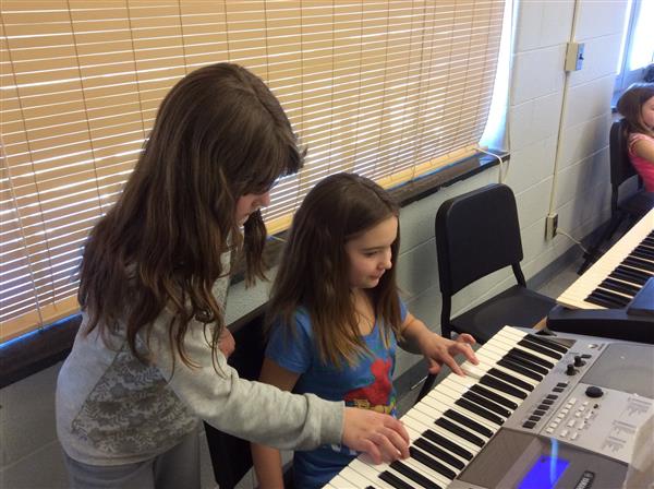 Clinton Street Fourth Graders playing a keyboard duet